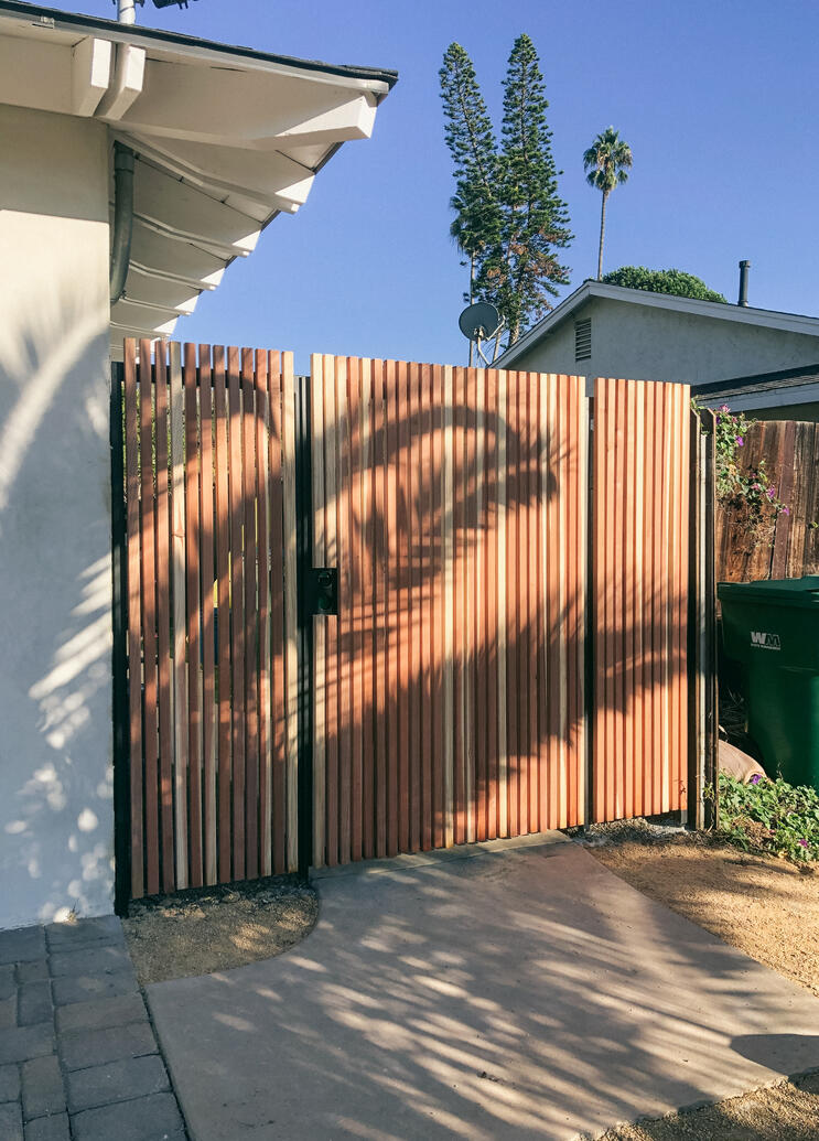 Metal gate and fence with redwood